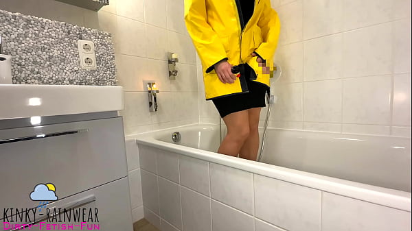 Gal In Yellow Rubber Raincoat Playing With A Rubber Duck Teaser
