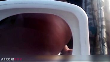 African With Mini Skirt Slams Herself With A Toy On The Chair