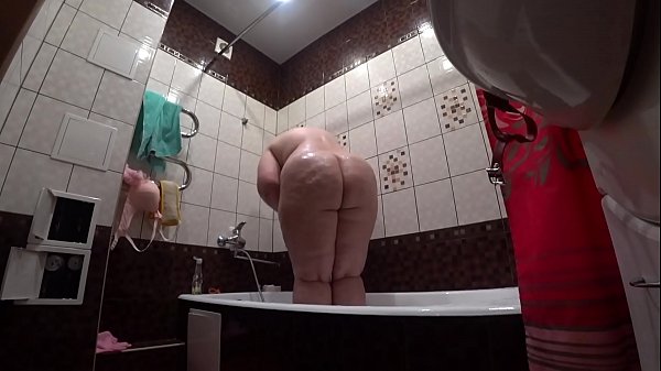 Behind The Scenes, A Hidden Camera Is Spying On A Fat Porn Model With A Massive Butt In The Bathroom.
