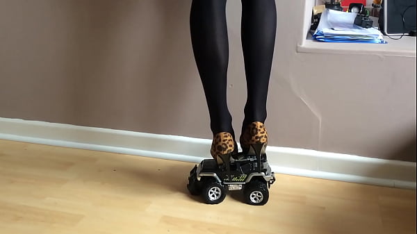 Toy Car Squeezed Under High Heels