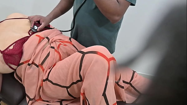 Indian Doctor Checking Miss Patient In Clinic