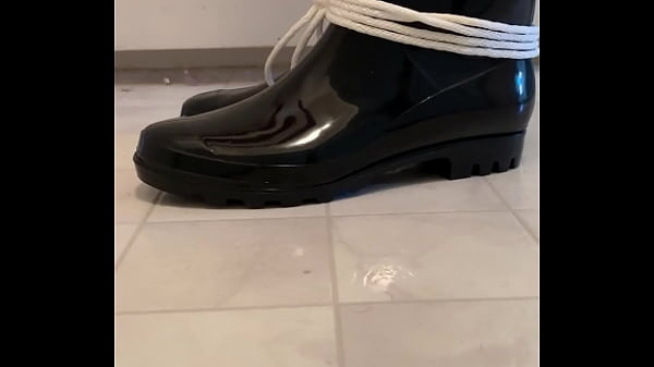 Rubber Boy Squeaks His Boots While Restrained