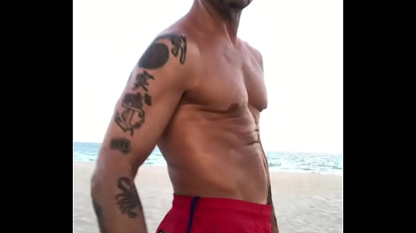 BICEP FLEXING AT THE BEACH