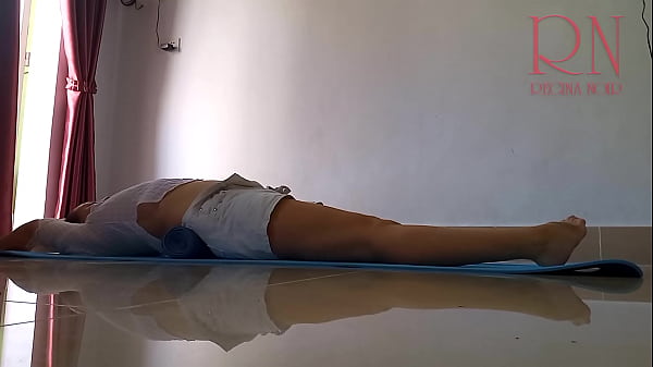 Regina Noir. A Female In White Shorts Practices Yoga In The Gym.