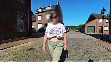 A Top-heavy Mature Walking In The Street Braless
