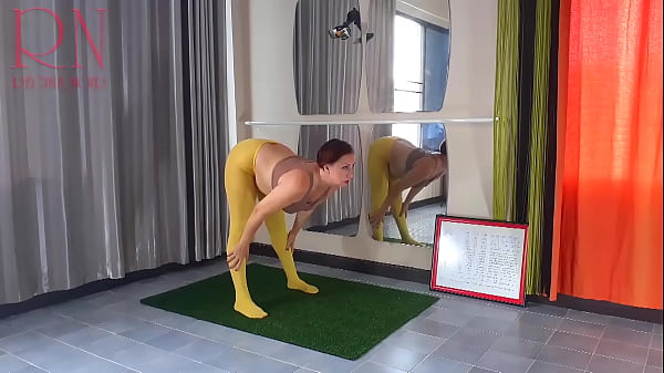 Regina Noir. Yoga In Yellow Tights Doing Yoga In The Gym. 1